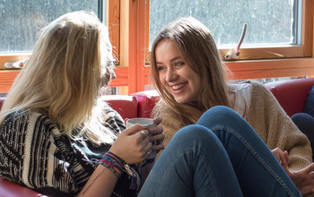 Two girls talking in their flat