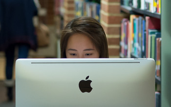 Girl using a computer in the library