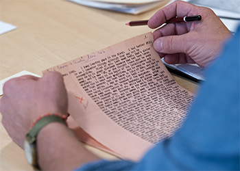 A person reading a manuscript