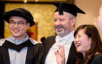 A student with an academic at a ceremony in China