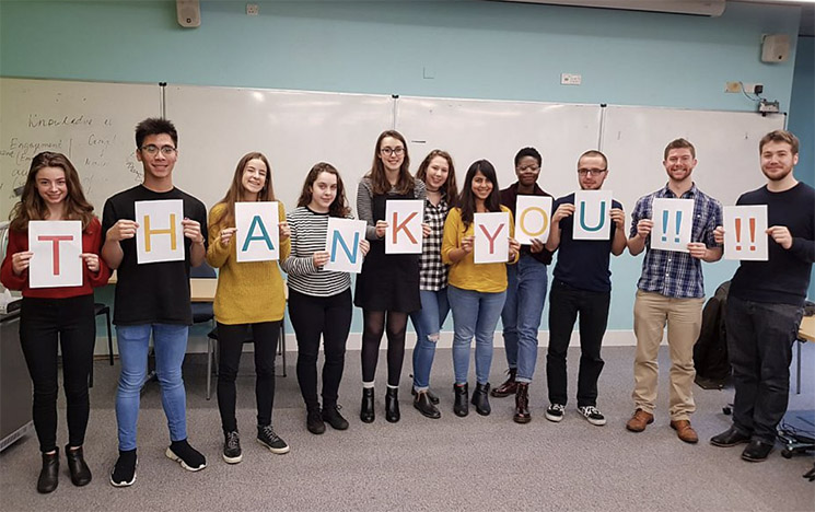 Students holding a thank you sign