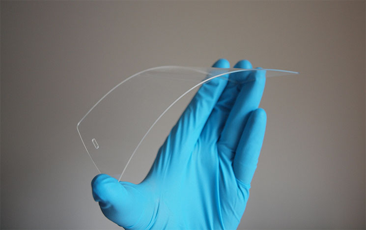 A hand holding mobile phone glass screen