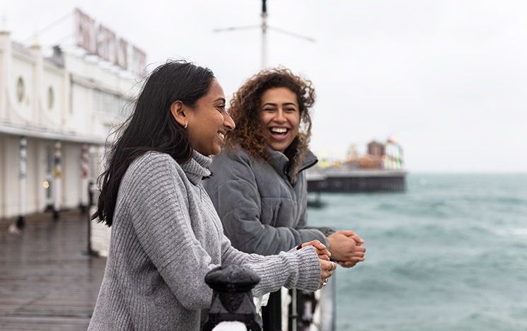 Two students looking out to sea from Brighton Palace Pier