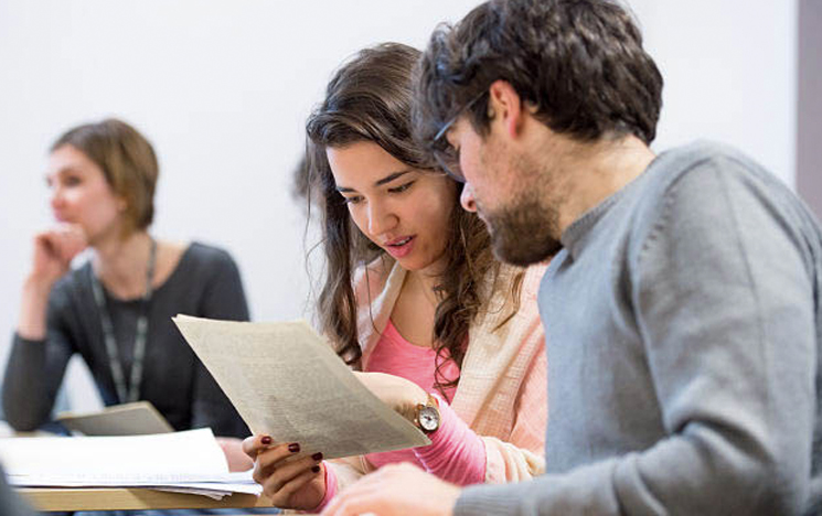 Students looking at scripts together