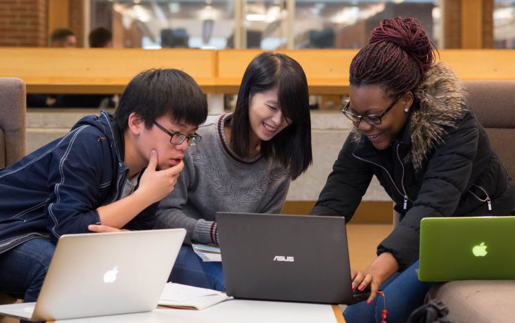 ICON: students sitting around laptops