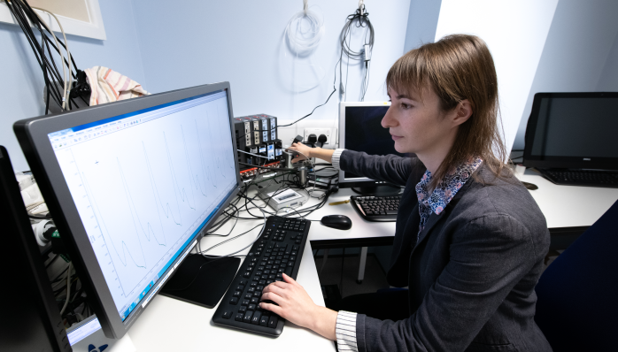 Charlotte Rae in a lab observing a graph on a computer