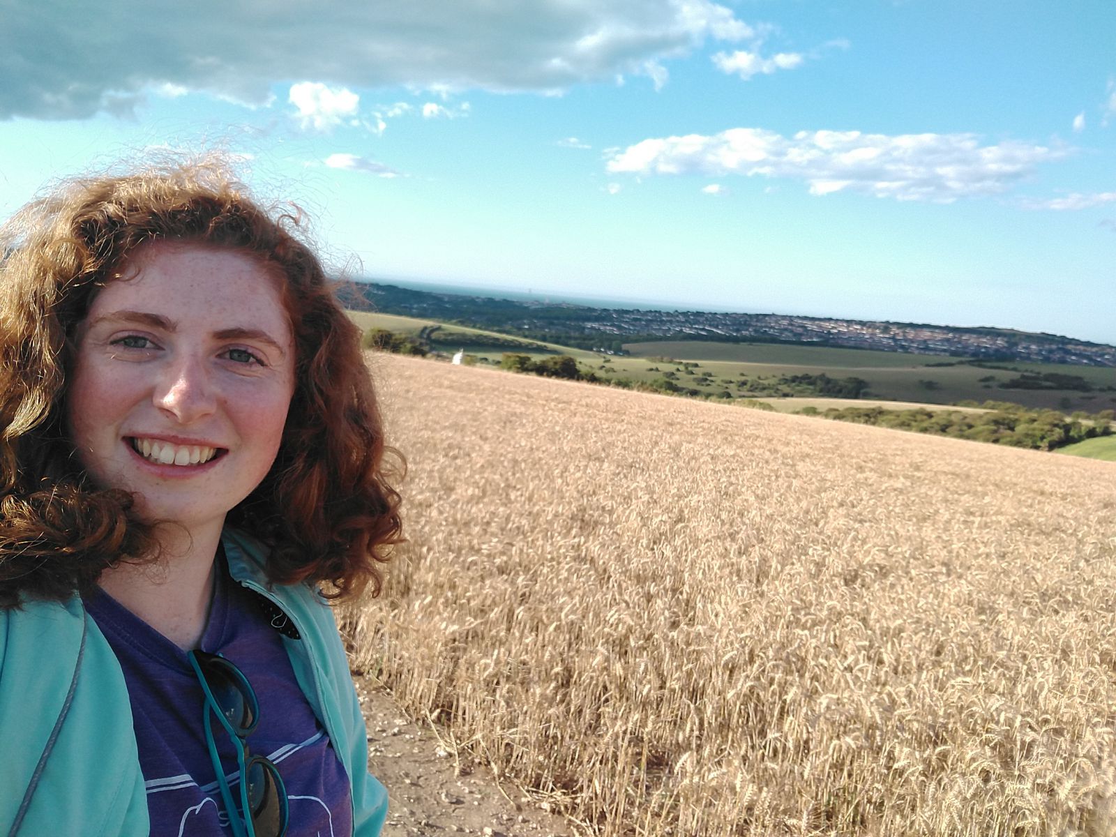 Ruthie on a walk up the South Downs, smiling at the camera