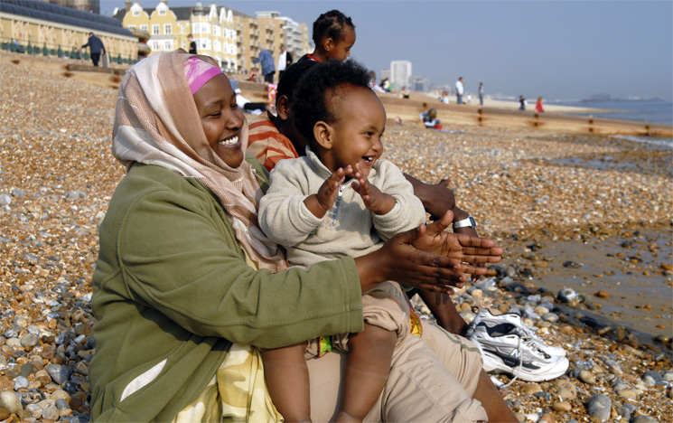 People sitting on Brighton Beach