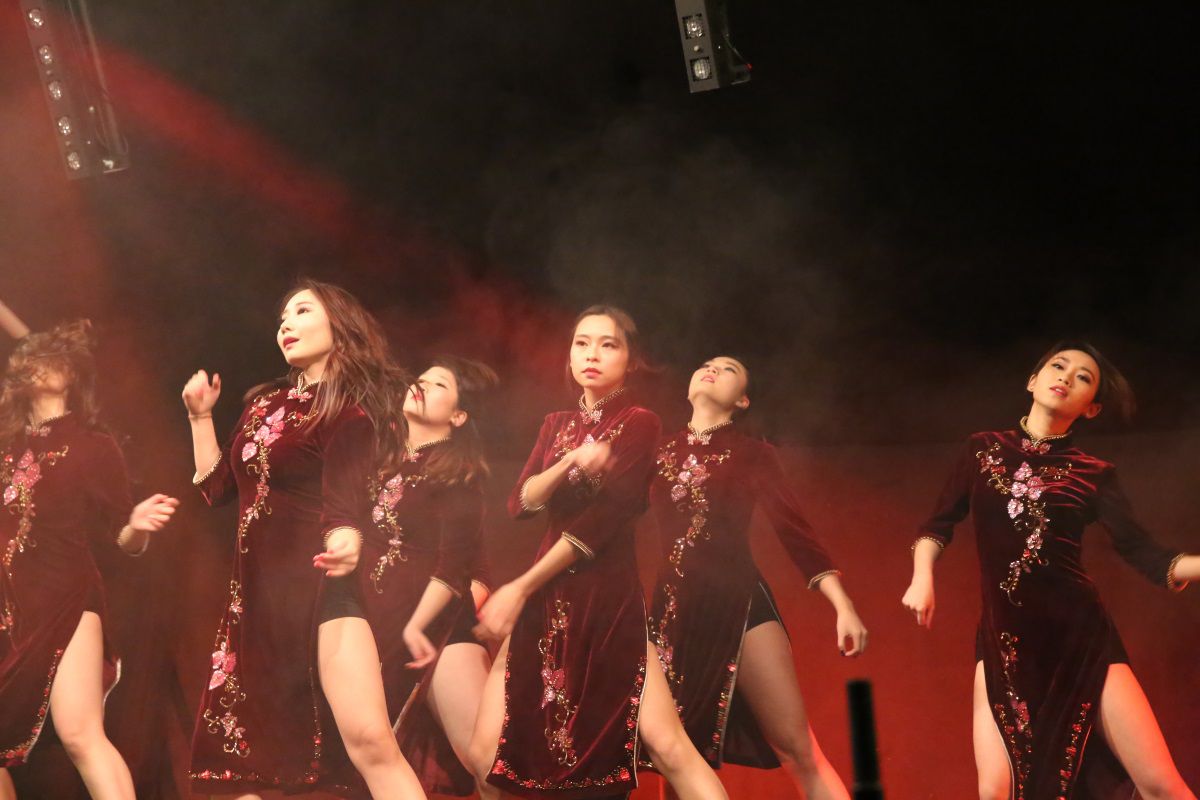 A troupe of student dancers on a stage