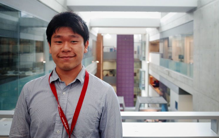 A student faces camera in a modern University building