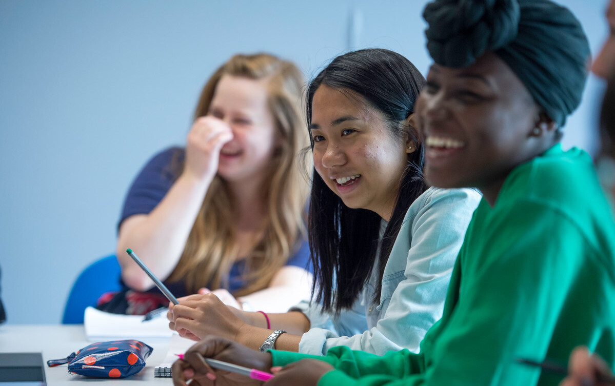 Female students laughing during seminar