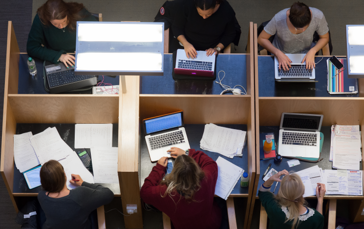 A top down shot of students studying in the library