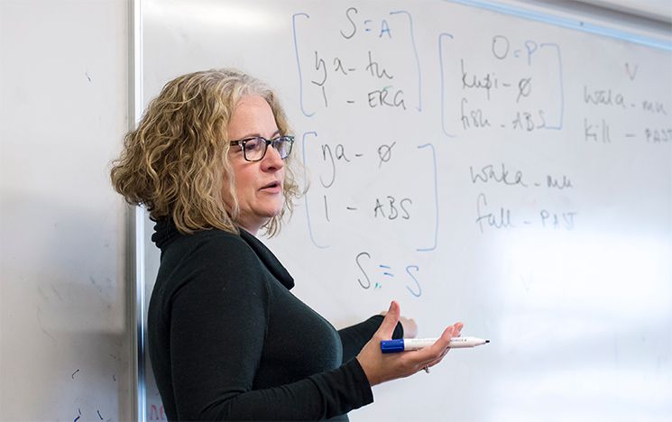 A lecturer writing on a whiteboard