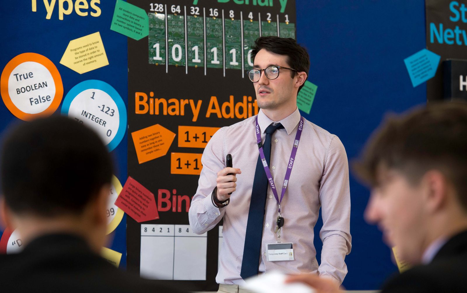 Male teacher stood at the front of class