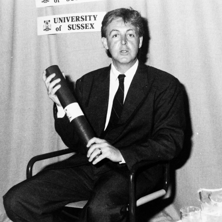 Black and white photo of Sir Paul McCartney at a Sussex graduation ceremony.