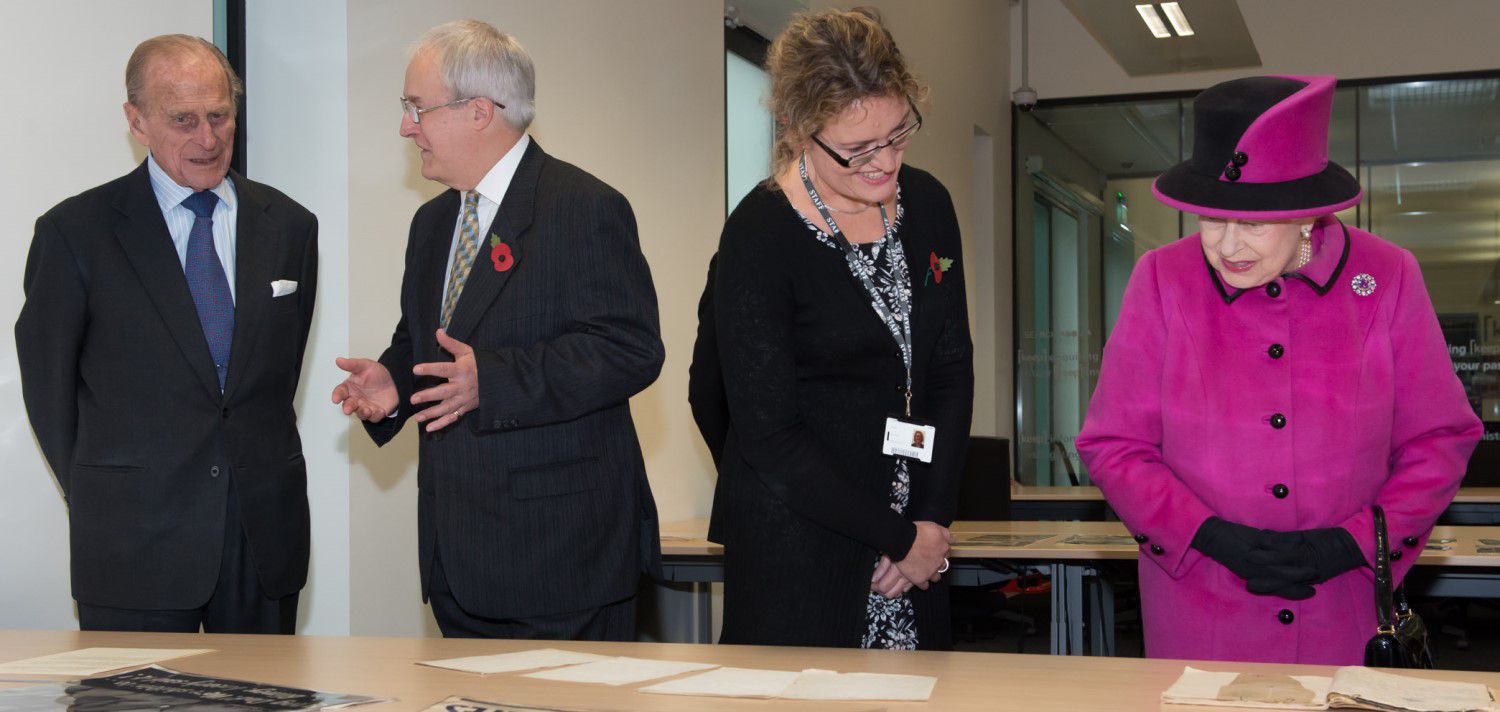 Chris Whittick, Senior Archivist at East Sussex County Council, speaks to the Duke of Edinburgh while Dr Fiona Courage shows Her Majesty the University's Special Collections archives