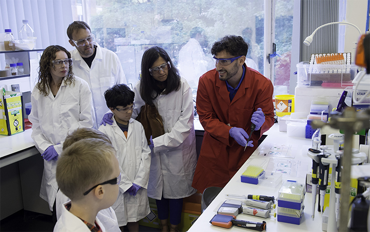Children watching a science experiment in a lab at the University of Sussex