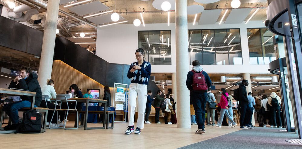 Decorative: Giving a view of Sussex students working in the student centre