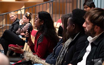 A student in the audience at a culture, equality and inclusion event asks a question.