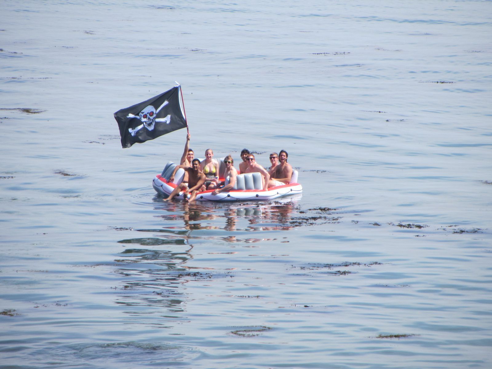 Students larking about in an inflatable boat