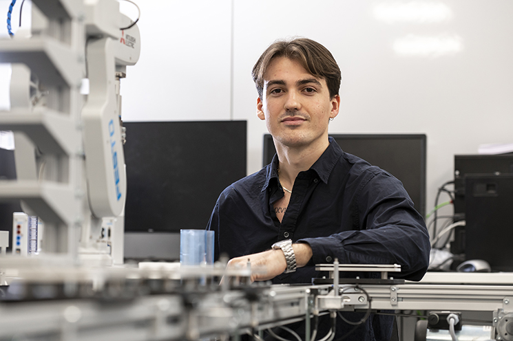 Image of James Napp with arm leaning on lab equipment