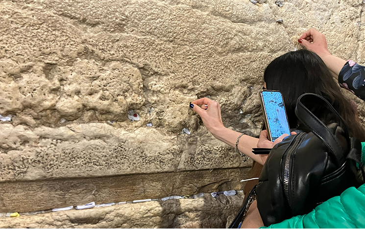 People leaving notes to God at Western Wall, Jerusalem