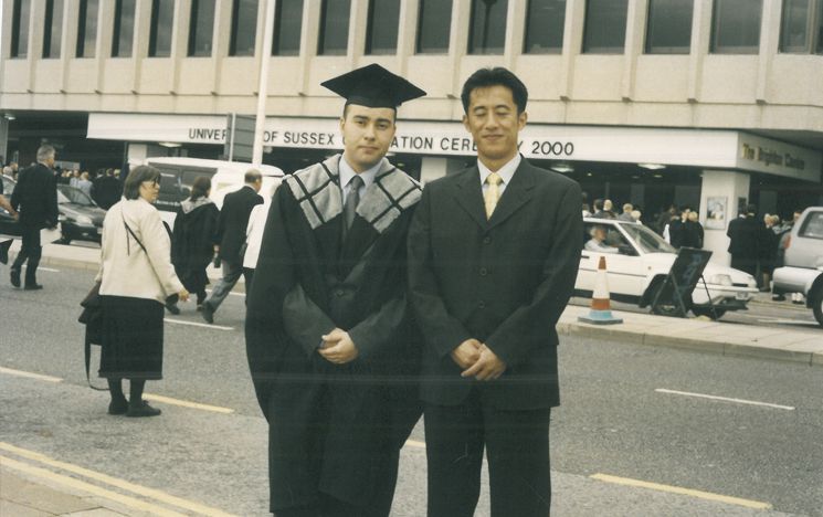 Okan Demirkan outside the Brighton Centre at graduation in 2000