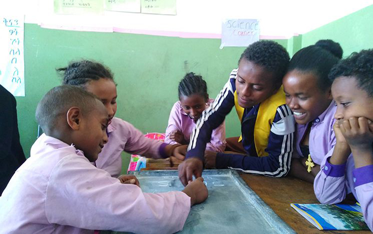 Children gathered together playing an educational game