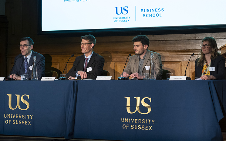 A panel of people sat at a talk