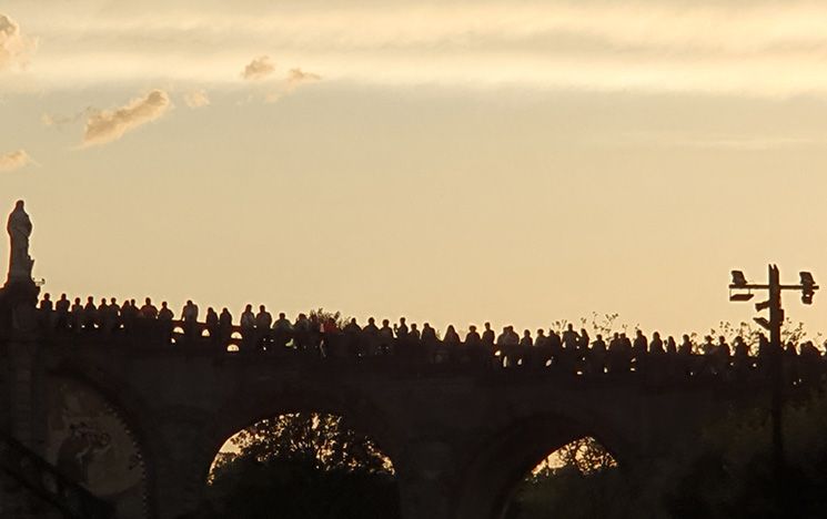 Pilgrims watching the Torchlight Procession.