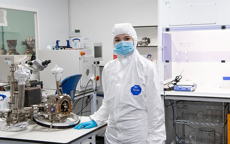 Student in protective clothing in quantum technology lab