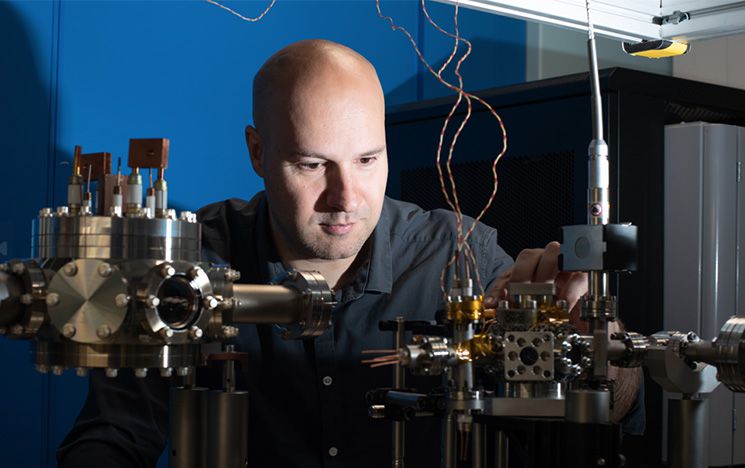 A researcher adjusting lab equipment