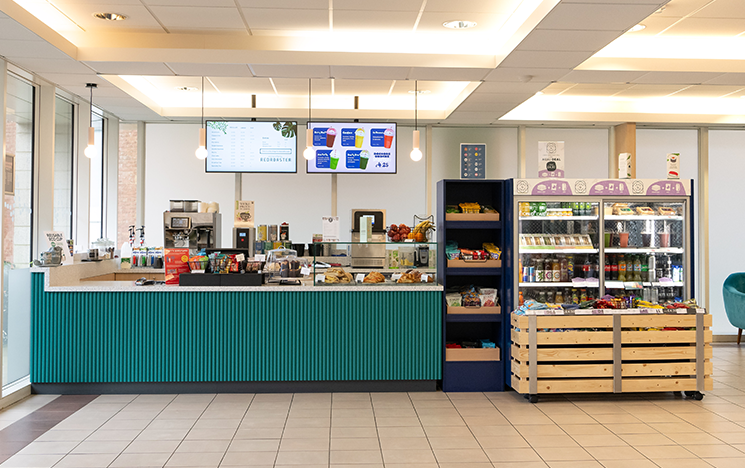 Spacious cafe with the counter and some parts of the seating area showing.