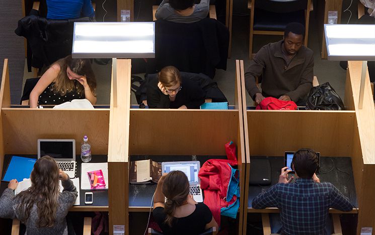 Students studying at booths in the library