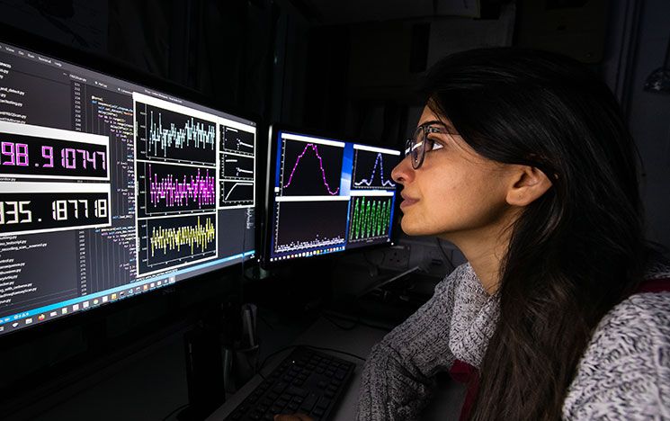 A student looking at a computer screen in a lab