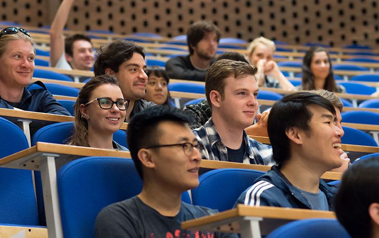 Students smiling and enjoying a lecture