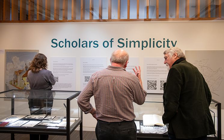 Attendees enjoying the Scholars of Simplicity exhibition