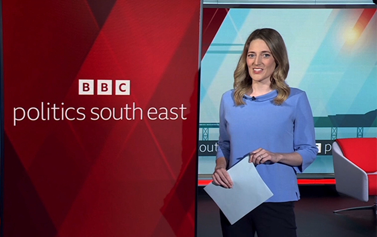 
A newsreader stands in front of the BBC Politics South East branding.