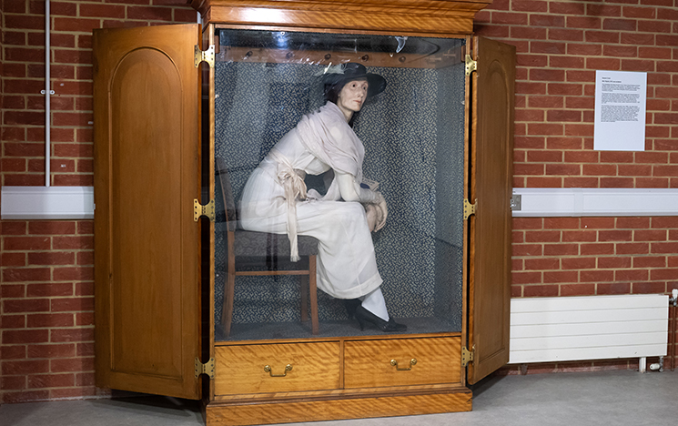 A large wooden cupboard contains Eleanor Crook's life-sized waxwork sculpture of Virginia Woolf