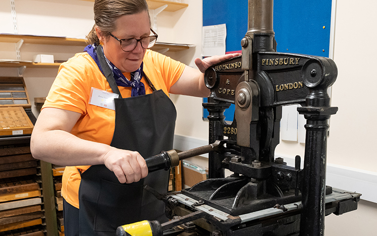 Keynote speaker Anne Fernald using the University's Victorian Albion printing press