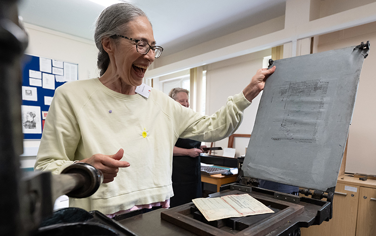 Artist Andrea Mindel using the University's Victorian Albion printing press