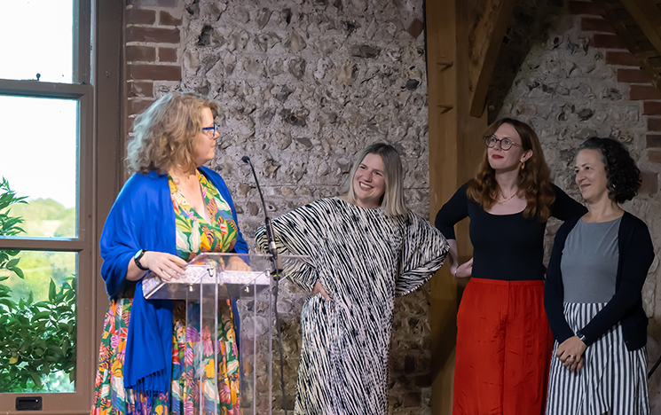 Conference organisers Clara Jones, Helen Tyson and Anna Snaith receiving thanks on stage at the Charleston banquet