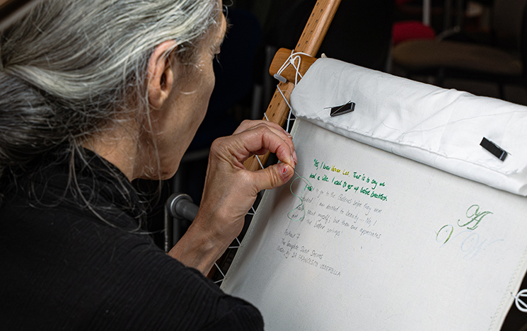 Artist Andrea Mindel working on her live embroidery at the Woolf conference