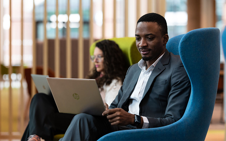 Students on their laptops at the student centre