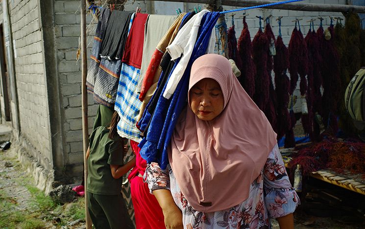 Woman standing near clothes washing line