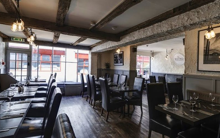 The interior of Il Bistro, with tables and chairs.