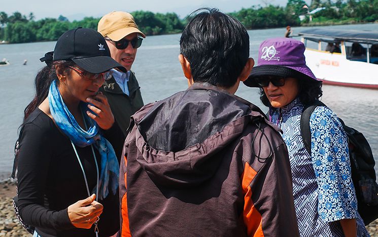 People talking next to the sea