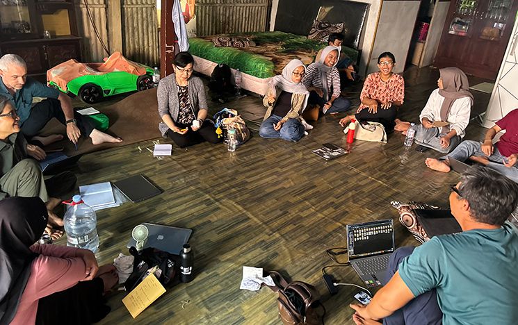 Group of people sitting on the floor in a circle