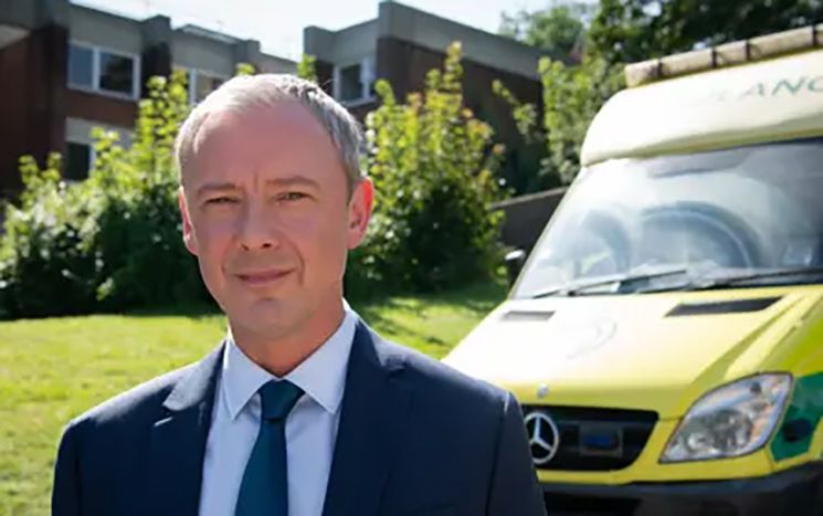 Grace actor in front of ambulance