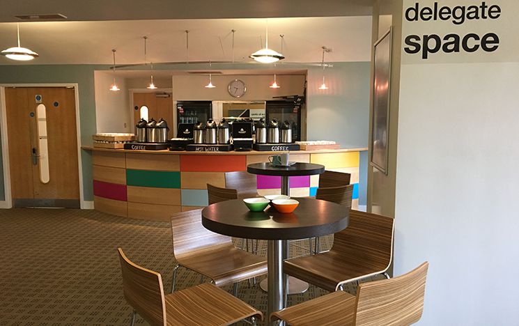 Tables and chairs with coffee counter in background